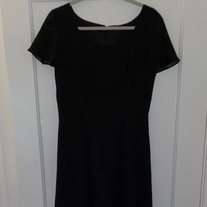 Floor length black gown with ruffled sleeves